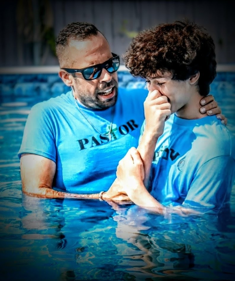 Pastor Joshua Pereira baptizing a student
